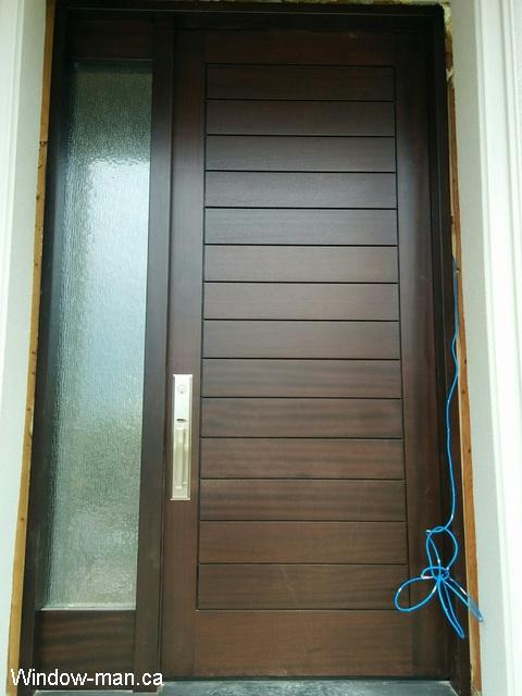 Solid wood door and one sidelight. 96 inches 8 foot door tall high. Professionally installed